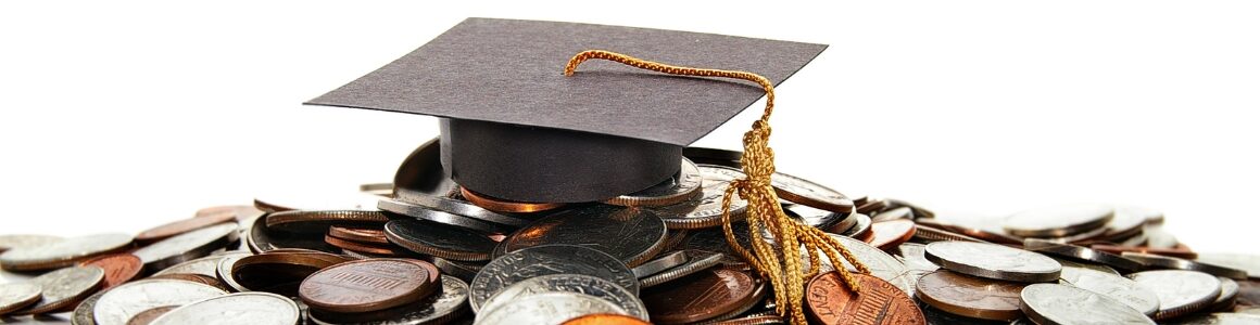 Graduation cap on top of coins